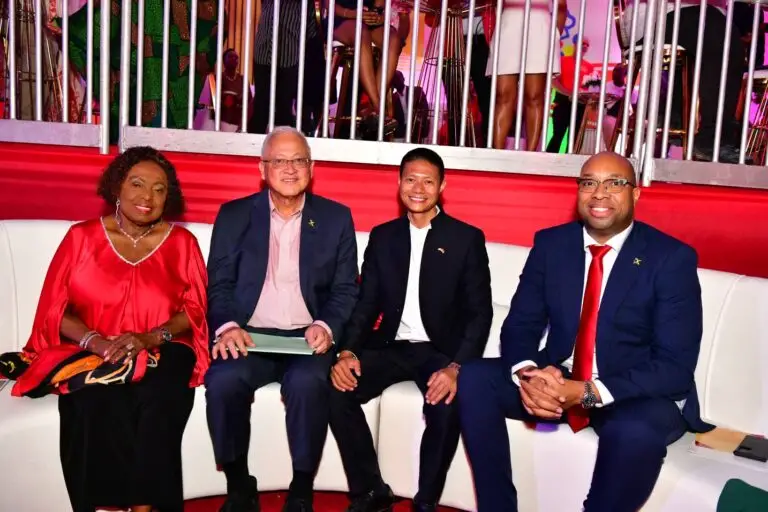 Yangsen Li (second right), chairman of Spring Festival 2026 which was held at his mega development, The Pinnacle, Sunday night, marks the moment with (from left) Minister of Culture, Gender, Entertainment and Sports Olivia Grange; Justice Minister Delroy Chuck, and state minister in the Ministry of Industry, Investment and Commerce, Delano Seiveright. They were inside the National Bakery lounge erected as part of the event. (Photo: Aceion Cunningham)
