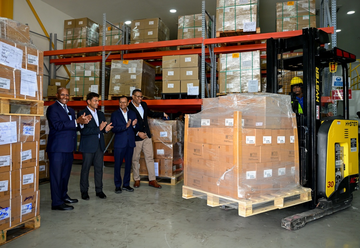 Photo by: Adrian Walker Minister of Industry, Investment and Commerce, Senator the Hon. Aubyn Hill (left), applauds as the first shipment of pharmaceutical items from Dr. Reddy’s Laboratories in Jamaica, destined for Guyana and Trinidad, is being lifted for loading on a truck. Occasion was a tour of the Dr. Reddy’s warehouse at 109 Marcus Garvey Drive, Kingston, on Thursday (February 5). The Minister is joined by (from left) Caribbean Head, Dr. Reddy’s Laboratories, Preet Darshi Patnaik; First Attaché (Administration and Commerce) from the High Commission of India, Hansraj Chhilwar; and General Manager, T. Geddes Grant, Christopher Curtis.