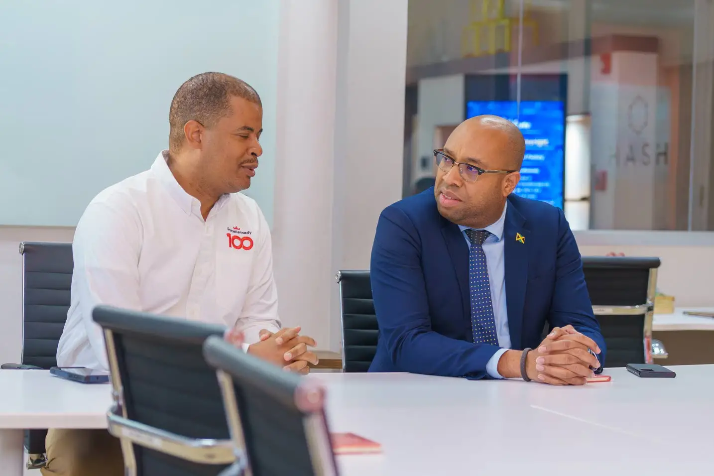 Minister of state in the Ministry of Industry, Investment and Commerce Delano Seiveright (right) in talks with Frank James, group CEO, GraceKennedy, during a tour of the company’s digital factory at Belmont Road in St Andrew on Wednesday.