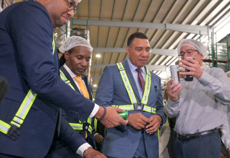 Photo by: Yhomo Hutchinson Prime Minister, Dr. the Most Hon. Andrew Holness (centre), looks at the contents of one of Wisynco Group Limited’s beer products being pointed out by the company's Chief Executive Officer, Andrew Mahfood (right), during a tour of the company’s newly opened brewery and manufacturing facility in Lakes Pen, St. Catherine, on January 13. Minister of State in the Ministry of Industry, Investment and Commerce, Hon. Delano Seiveright (left), and State Minister in the Ministry of Foreign Affairs and Foreign Trade, Hon. Alando Terrelonge, were also on the tour.