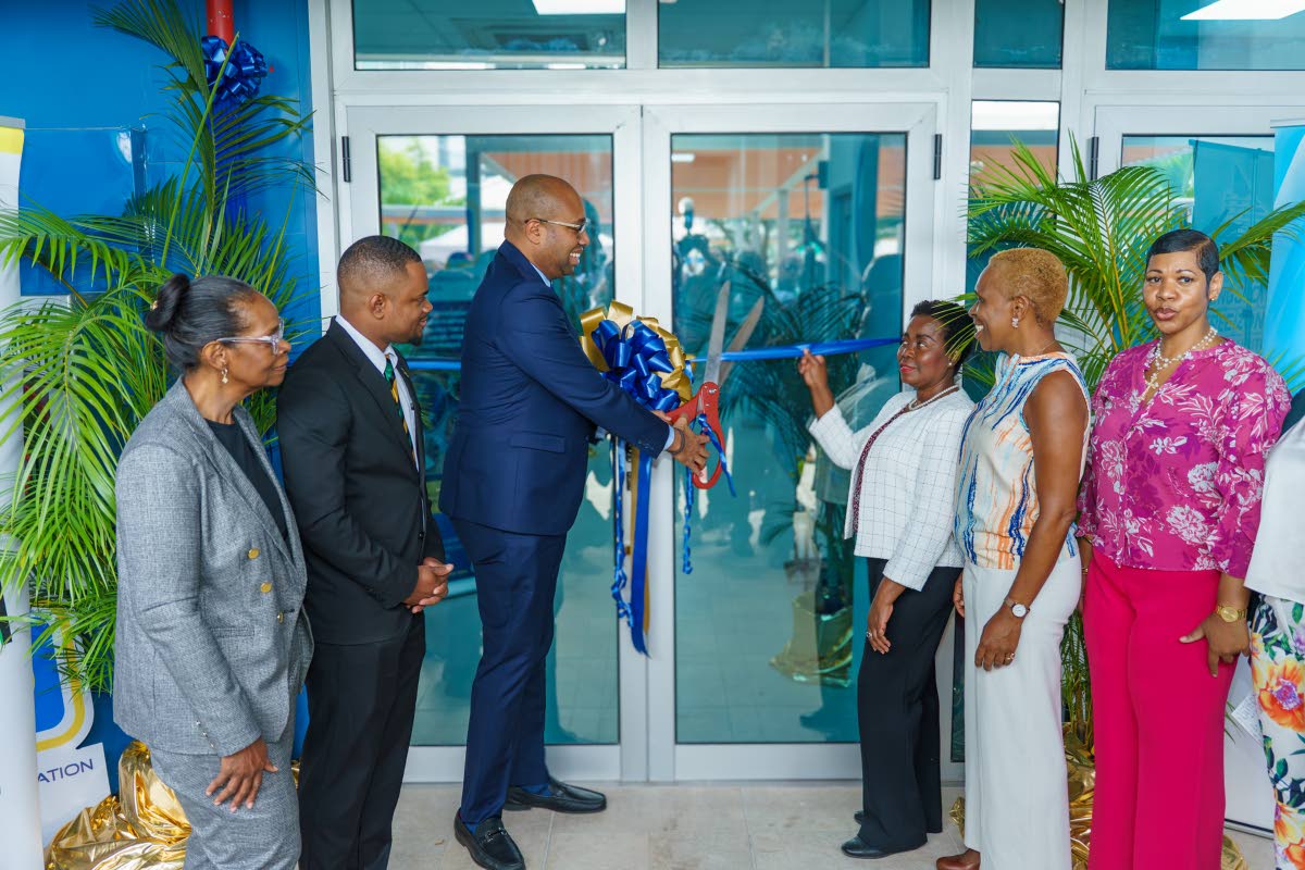 From left: Acting Vice-President at JAMPRO, Gail Barrett; Kingston Free Zone Director, Demoy Kerr; Minister of State in the Ministry of Industry, Investment and Commerce, Delano Seiveright; Vice-President of BPO and Logistics at the Port Authority of Jamaica (PAJ), Gloria Henry; Senior Vice-President of Finance at the PAJ, Elva Williams Richards; Assistant Vice-President of Communications at the PAJ, Kimberley Stiff; and Assistant Vice-President at the Kingston Free Zone, Glenice Leachman, cut the ribbon to officially open a facility at the Portmore Informatics Park.