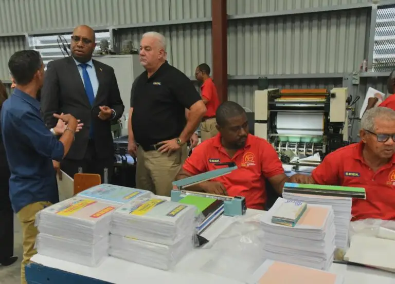 State minister in the Ministry of Industry, Investment and Commerce Delano Seiveright (second left), in conversation with managing director, Stationery & Office Supplies Limited (SOS) Allan McDaniel (left), and manager, manufacturing, SEEK Bruce Baylis, during a tour of the new SEEK factory on Friday. Also present are SEEK book packers Oliver Robinson (second right) and Donald Forbes. (Photo: JIS)