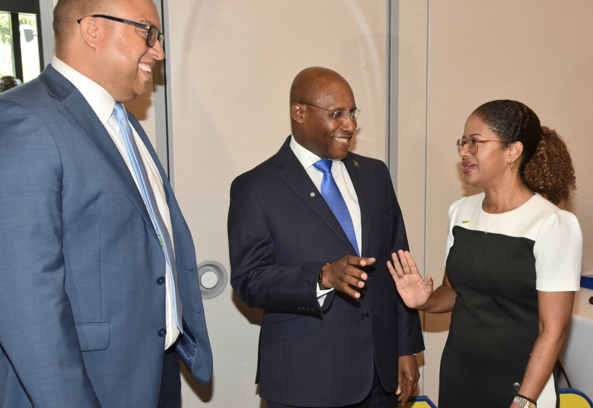 Minister of Industry, Investment and Commerce, Senator the Hon. Aubyn Hill (centre) in discussion with Interim Chief Executive Officer, National Commercial Bank Jamaica Limited (NCB), Sheree Martin (right) and Executive Vice President, Retail Banking Division, National Commercial Bank Jamaica Limited, Perrin Gayle during the NCB SME Growth Fund II luncheon at the AC Marriot Hotel in New Kingston on April 16.
