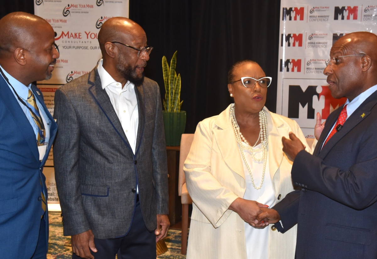 Minister of Industry, Investment and Commerce, Senator the Hon. Aubyn Hill (right), in discussion with (from left) President of the Jamaica Chamber of Commerce, Emile Leiba; Founder of the Transformed Life Church, Bishop Dwight Fletcher, and Managing Director of Make Your Mark Consultants, Dr. Jacquiline Coke-Lloyd, at the Annual Middle Managers Leadership Conference, held at The Jamaica Pegasus hotel in New Kingston on May 6.