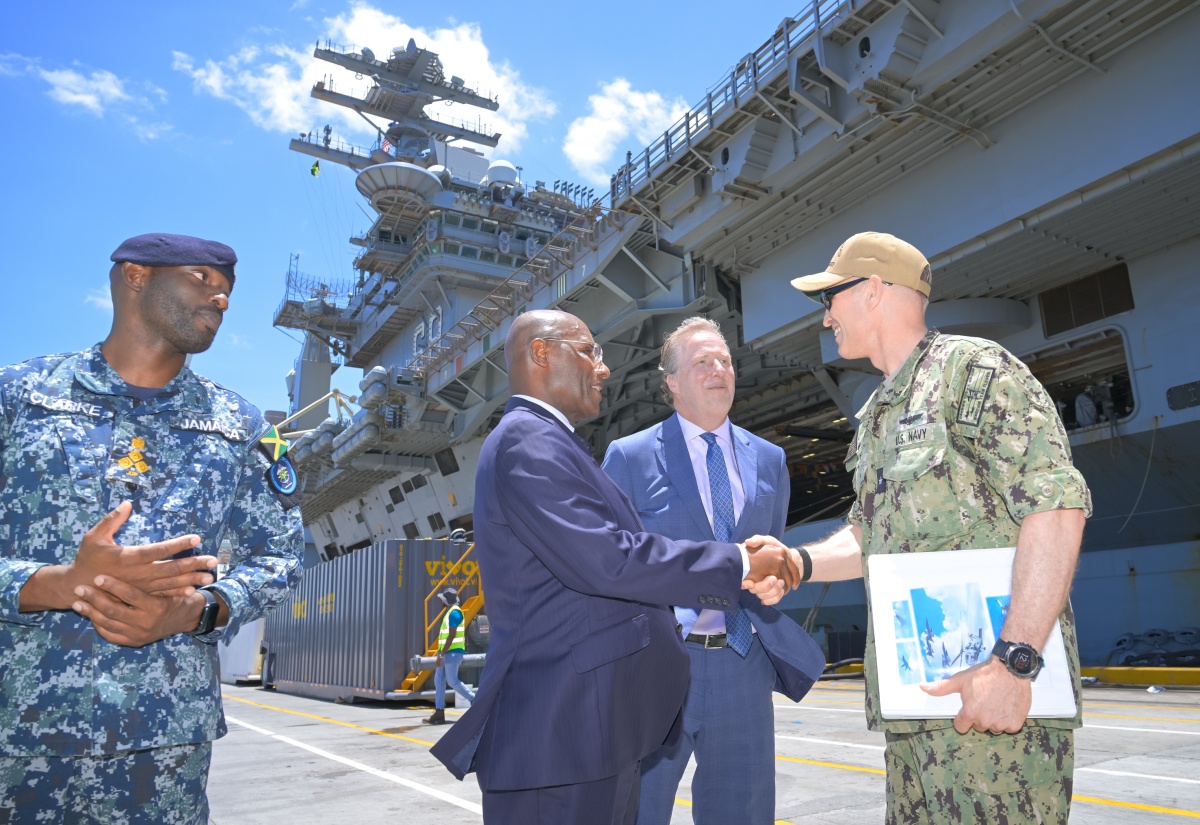 Minister of Industry, Investment and Commerce, Senator the Hon. Aubyn Hill (second left) greets Commander of Carrier Strike Group 11on the USS Nimitz, Rear Admiral Cassidy Norman (right) at the arrival ceremony and media tour of the vessel at the Kingston Freeport Terminal on Monday (June 1). Sharing in the moment (from left) are Brigade Commander of Maritime, Air and Cyber Command (MACC) at the Jamaica Defence Force (JDF) Brigadier Elon Clarke and United States Embassy Chargé d’Affaires Scott Renner.