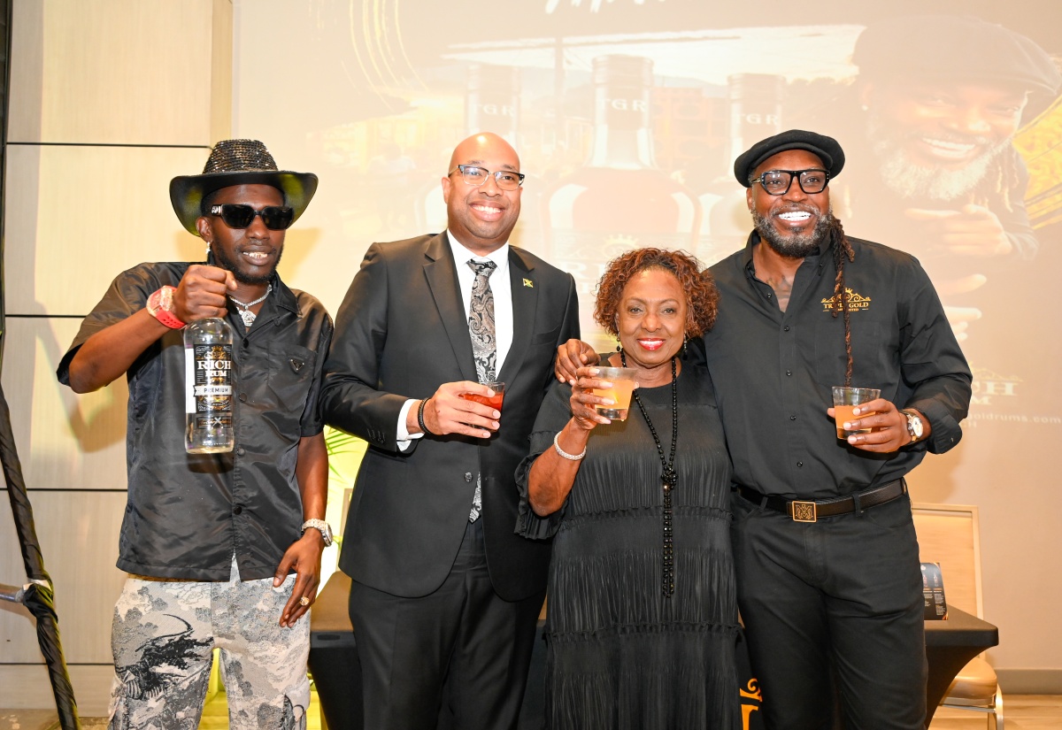Minister of State in the Ministry of Industry, Investment and Commerce, Hon. Delano Seiveright (second left), shares a moment with Minister of Culture, Gender, Entertainment and Sport, Hon. Olivia “Babsy” Grange (third left), cricket legend and entrepreneur Christopher “Chris” Gayle (right), and Dancehall Entertainer, Tanto Black, at the official launch of Rich Rum by Triple Gold Rums Limited at the AC Hotel Kingston, on Wednesday, July 8.