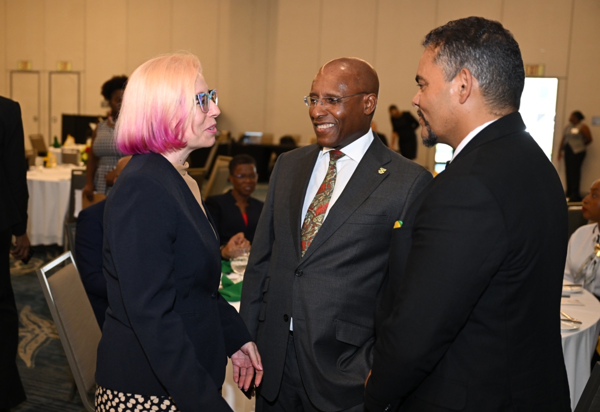 Minister of Industry, Investment and Commerce, Senator the Hon. Aubyn Hill (centre), and the Republic of South Africa’s Deputy Minister of International Relations and Cooperation, Hon. Alvin Botes, engage in conversation with Jamaica Manufacturers and Exporters Association (JMEA) President, Kathryn Silvera, during a High-Level Ministerial Luncheon at the AC Hotel by Marriott Kingston on Wednesday (August 5). Mr. Botes is on an Official Visit to Jamaica from August 4 to 8