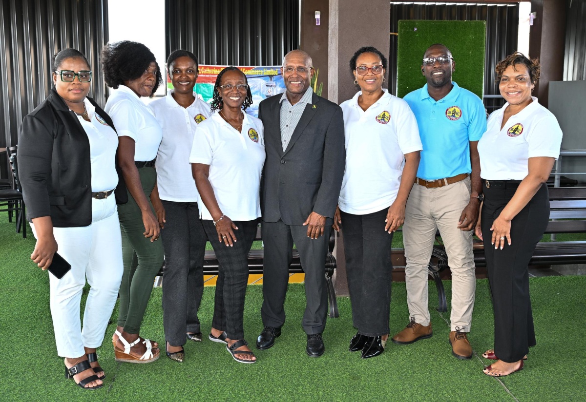 Minister of Industry, Investment and Commerce, Senator the Hon. Aubyn Hill (fourth right) is joined by members of the South St. Catherine Chamber of Commerce during the entity's luncheon meeting on Saturday (August 15) at Rooftop Chillinz Restaurant in Old Harbour.