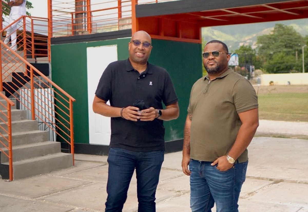 Minister of State, Ministry of Industry, Investment and Commerce, Hon. Delano Seiveright (left), and Project Lead, Social Yard development, Minkah Lim-Tom, tour the project site at the Constant Spring Football Field, St. Andrew. The project is expected to create opportunities for entrepreneurship, small business growth and employment within the Constant Spring-Manor Park area.