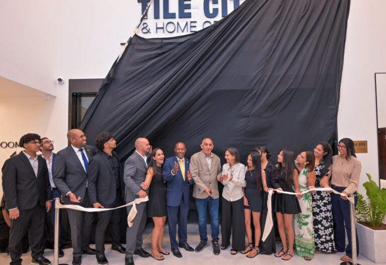 Minister of Industry, Investment and Commerce, Senator the Hon. Aubyn Hill (seventh left), and State Minister, Hon. Delano Seiveright (third left), join founding directors, partners and family members in cutting the ribbon and unveiling the sign during the official opening of the Tile City & Home Centre Signature Showroom on Constant Spring Road in Kingston on Thursday (October 8).